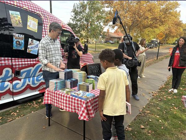 Students receiving books